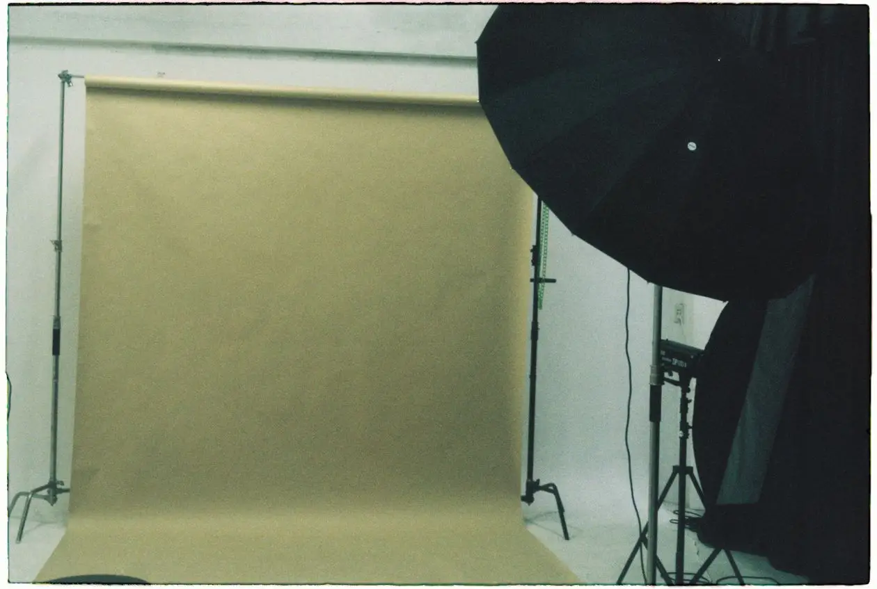 Empty photography studio set up with backdrop and softbox lighting, ready for a corporate headshot day
