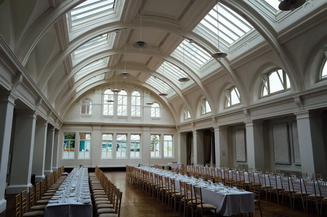 Elegant banquet hall with arched skylight ceiling set up for a formal gala event in the UAE