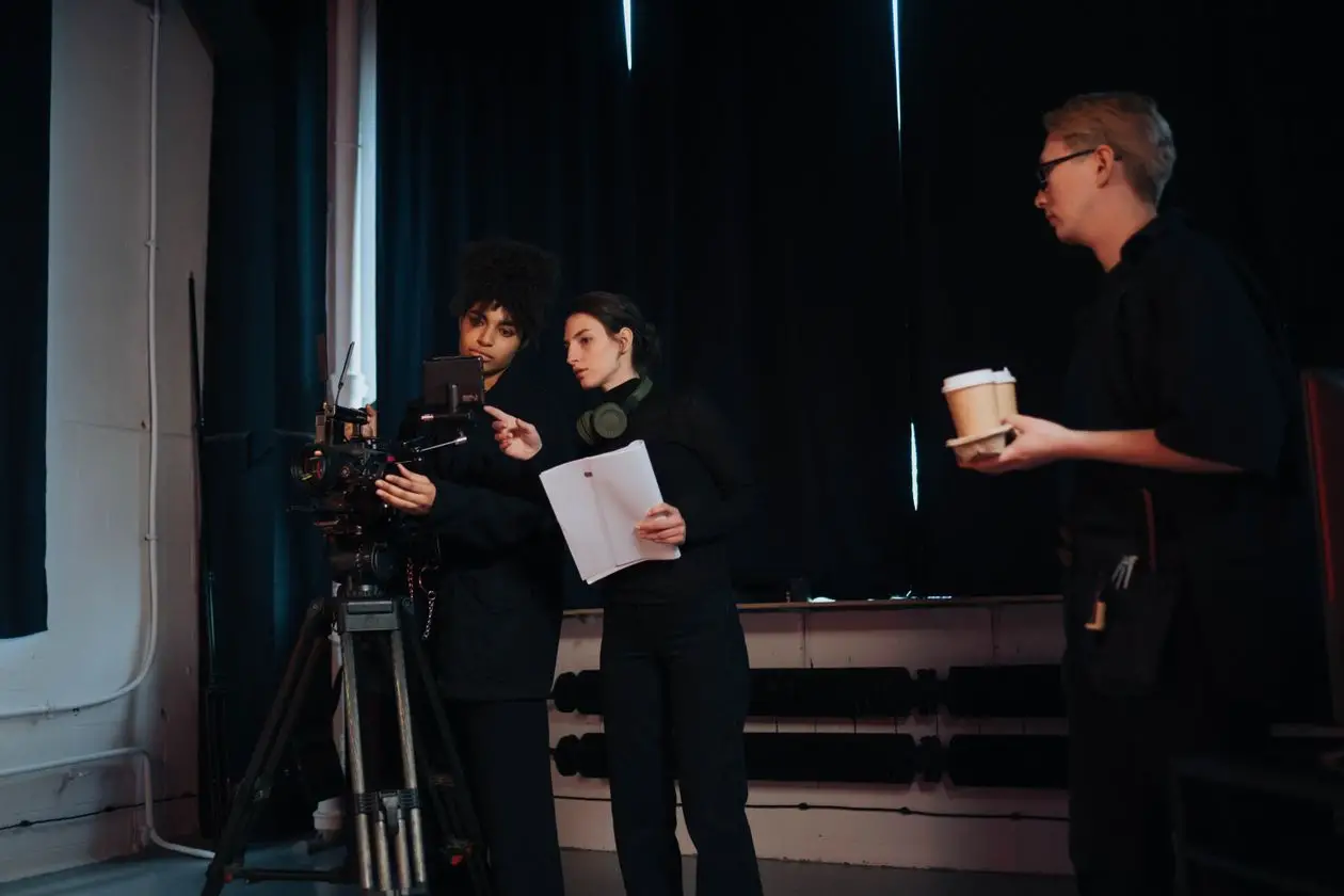 Film crew members collaborating on set, discussing camera operations and planning during a production