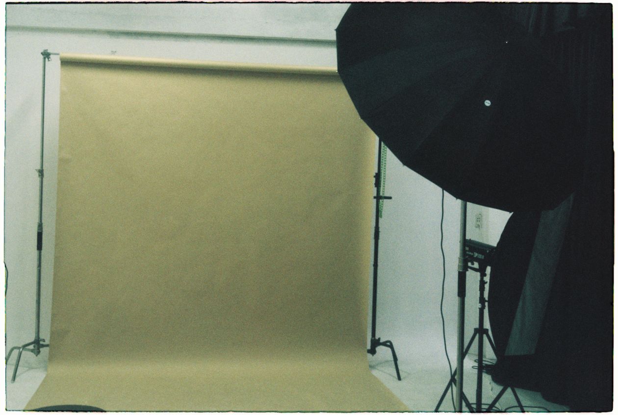 Empty photography studio set up with backdrop and softbox lighting, ready for a corporate headshot day