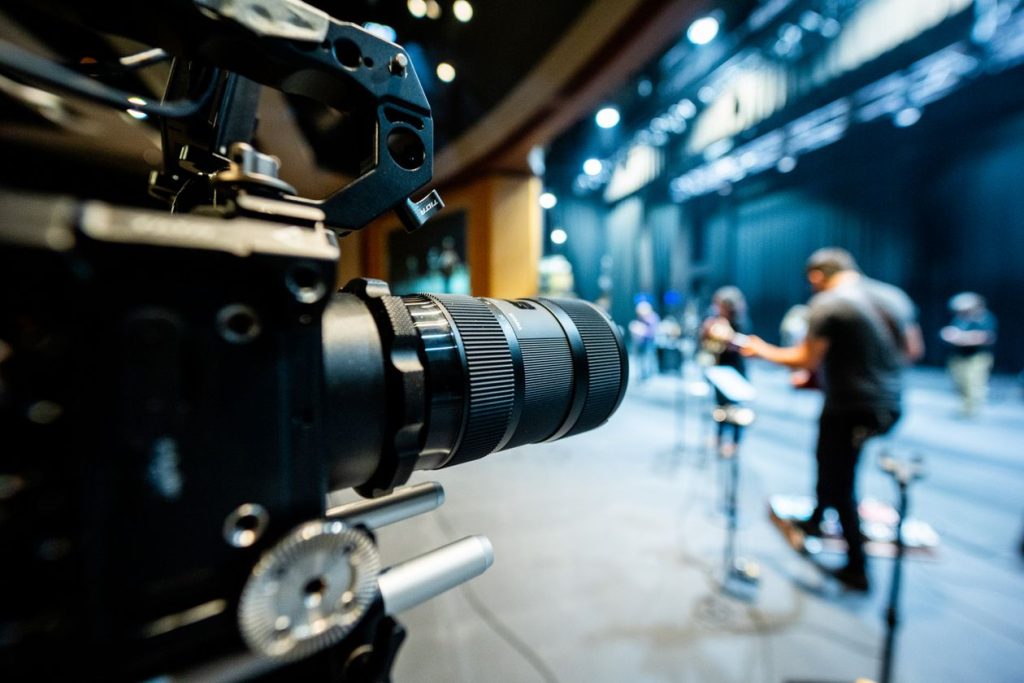 Multiple video cameras capturing a live stage performance, multi-camera event recording setup