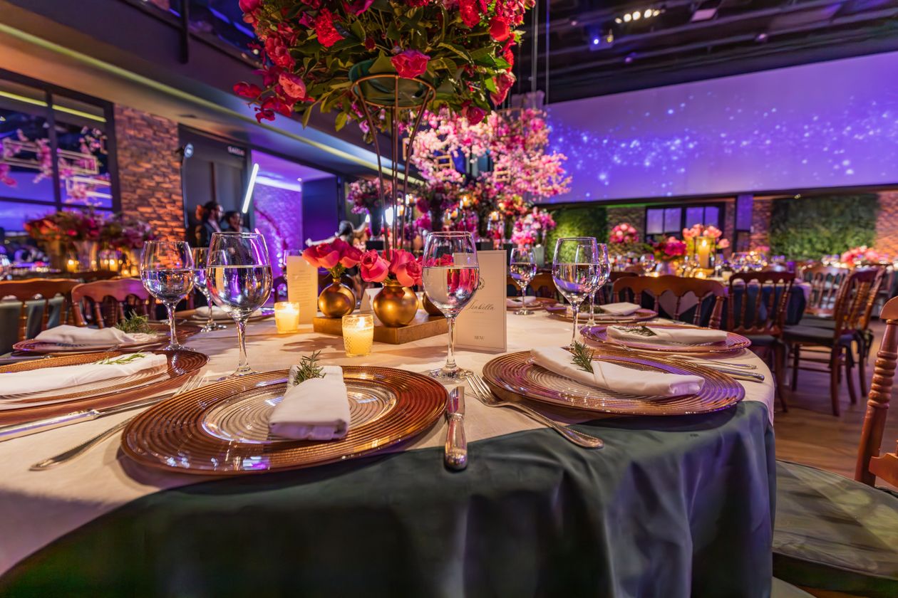 Luxurious gala table setting with flowers, candles, and crystal glassware for a formal awards dinner