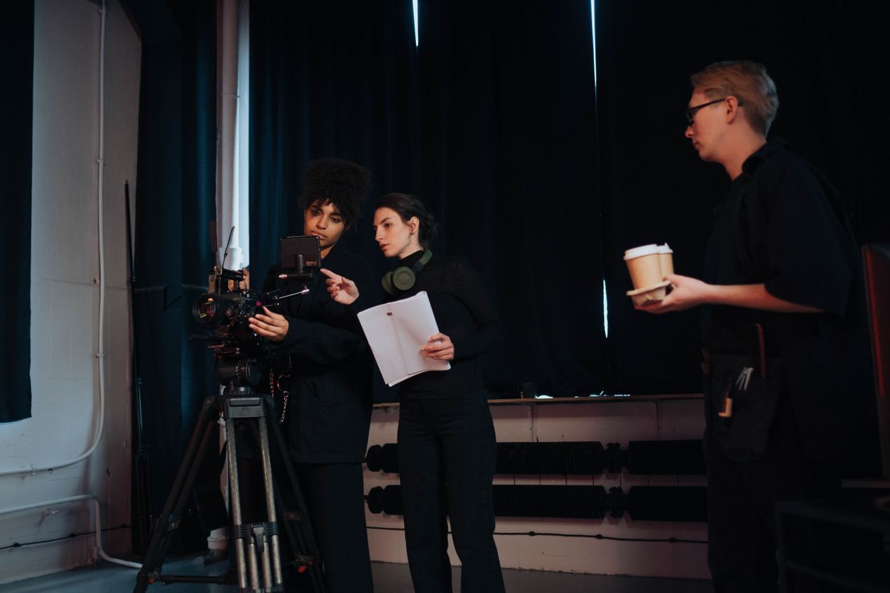 Film crew members collaborating on set, discussing camera operations and planning during a production