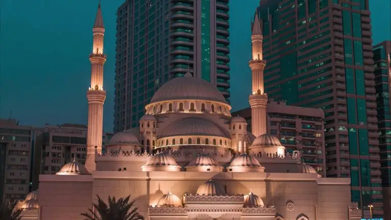 Aerial view of Sharjah mosques and city at sunset